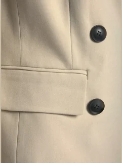 Blazer court à col à revers avec manches longues et poches