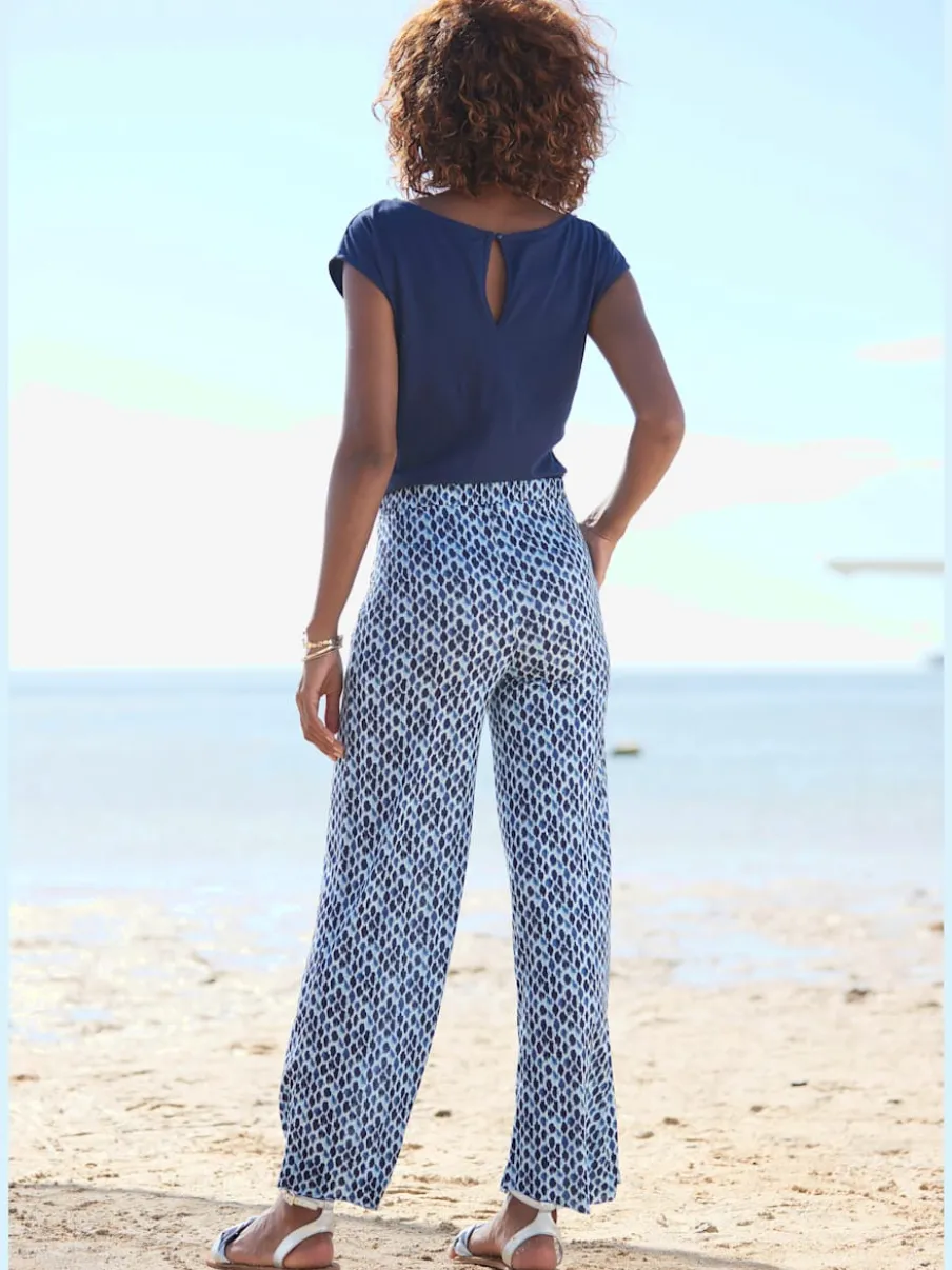 Combinaison avec col arrondi et manches courtes en viscose fluide à jambes extra-larges et poches fendues