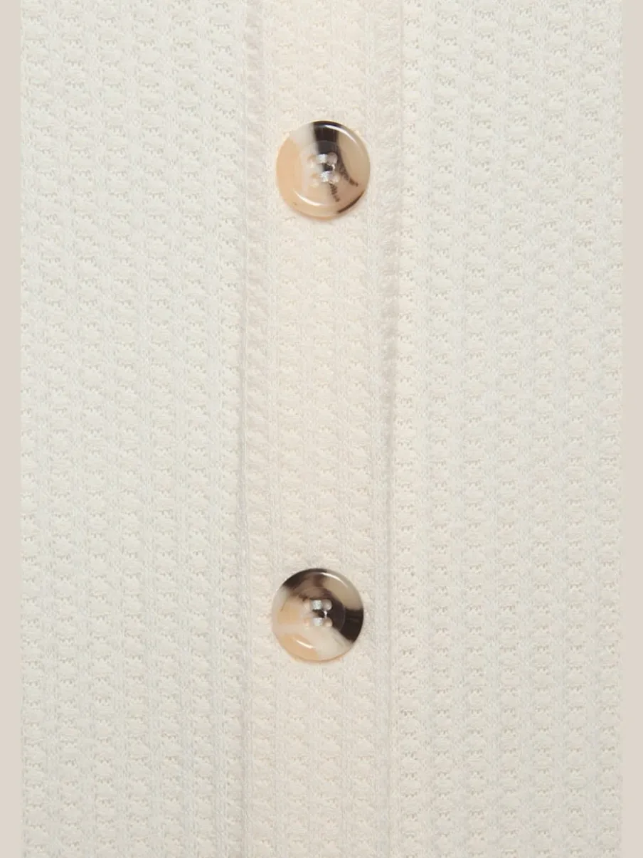 Débardeur sans manches avec patte de boutonnage et ceinture élastiquée