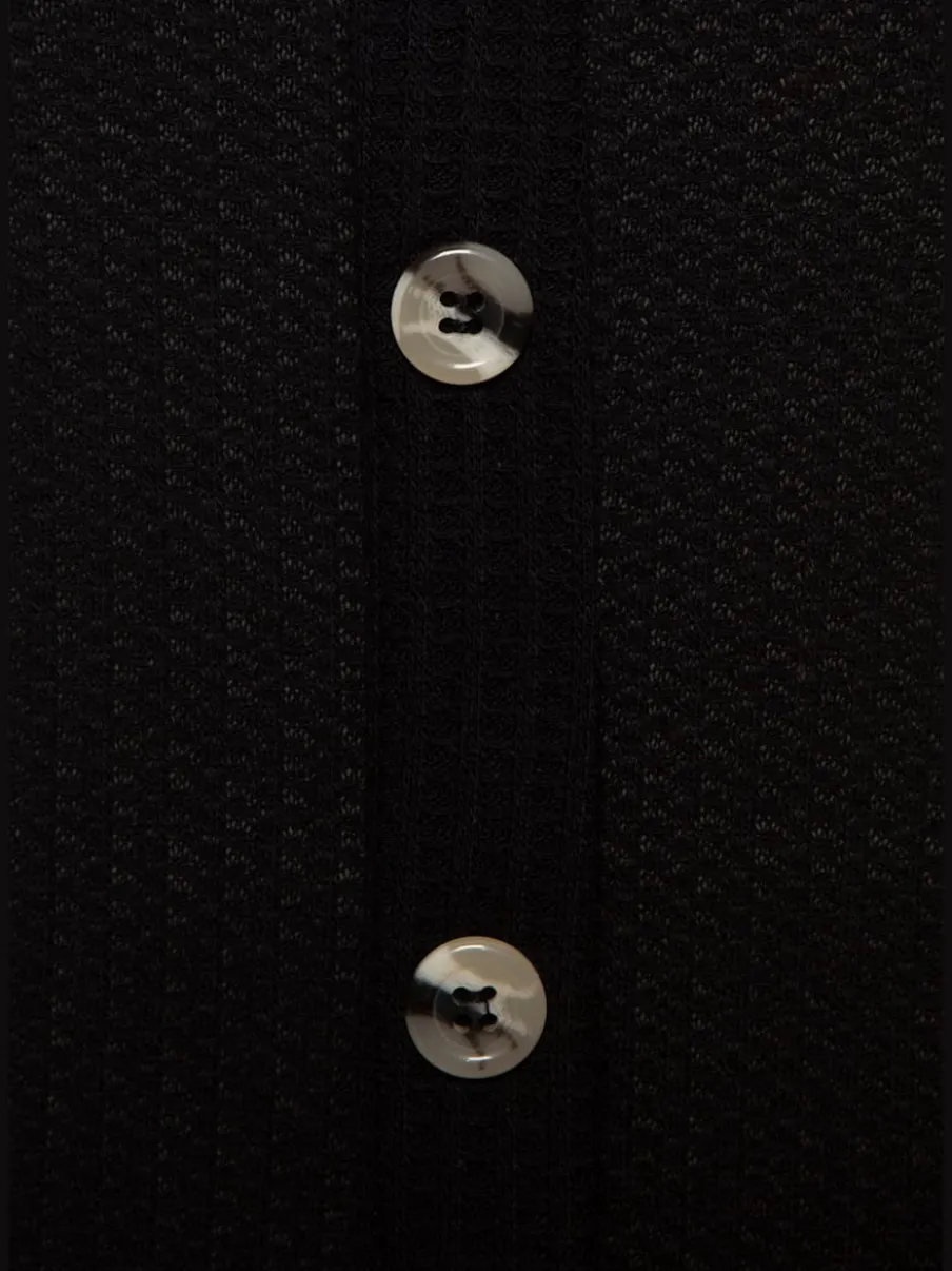Débardeur sans manches avec patte de boutonnage et ceinture élastiquée
