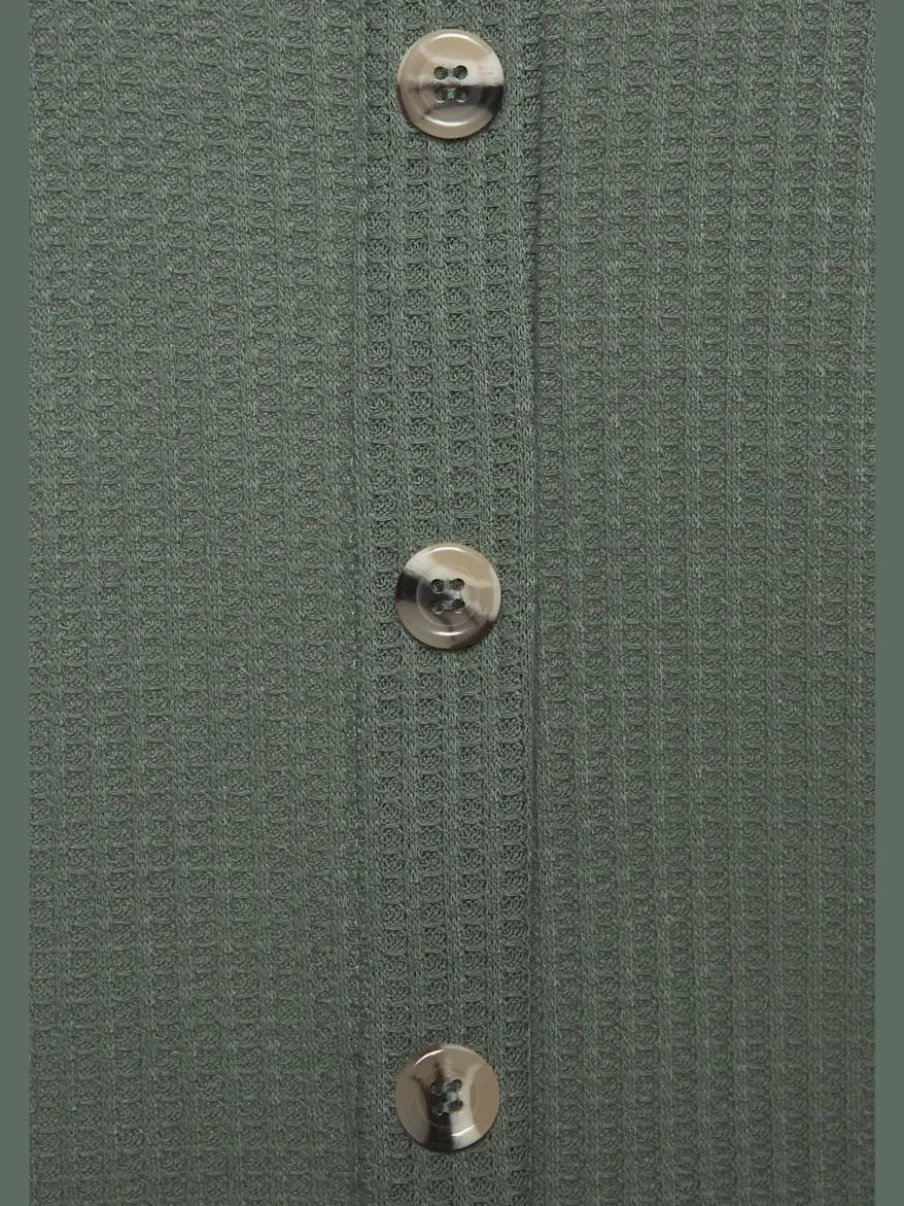 Débardeur sans manches avec patte de boutonnage et ceinture élastiquée