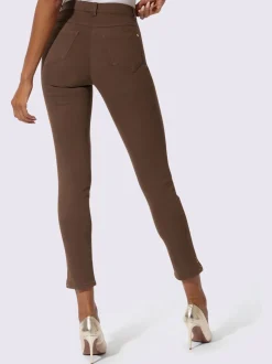 Jean extensible à fausse fermeture avec pierres brillantes et fente
