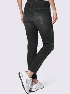 Jean slim cinq poches avec délavage et paillettes
