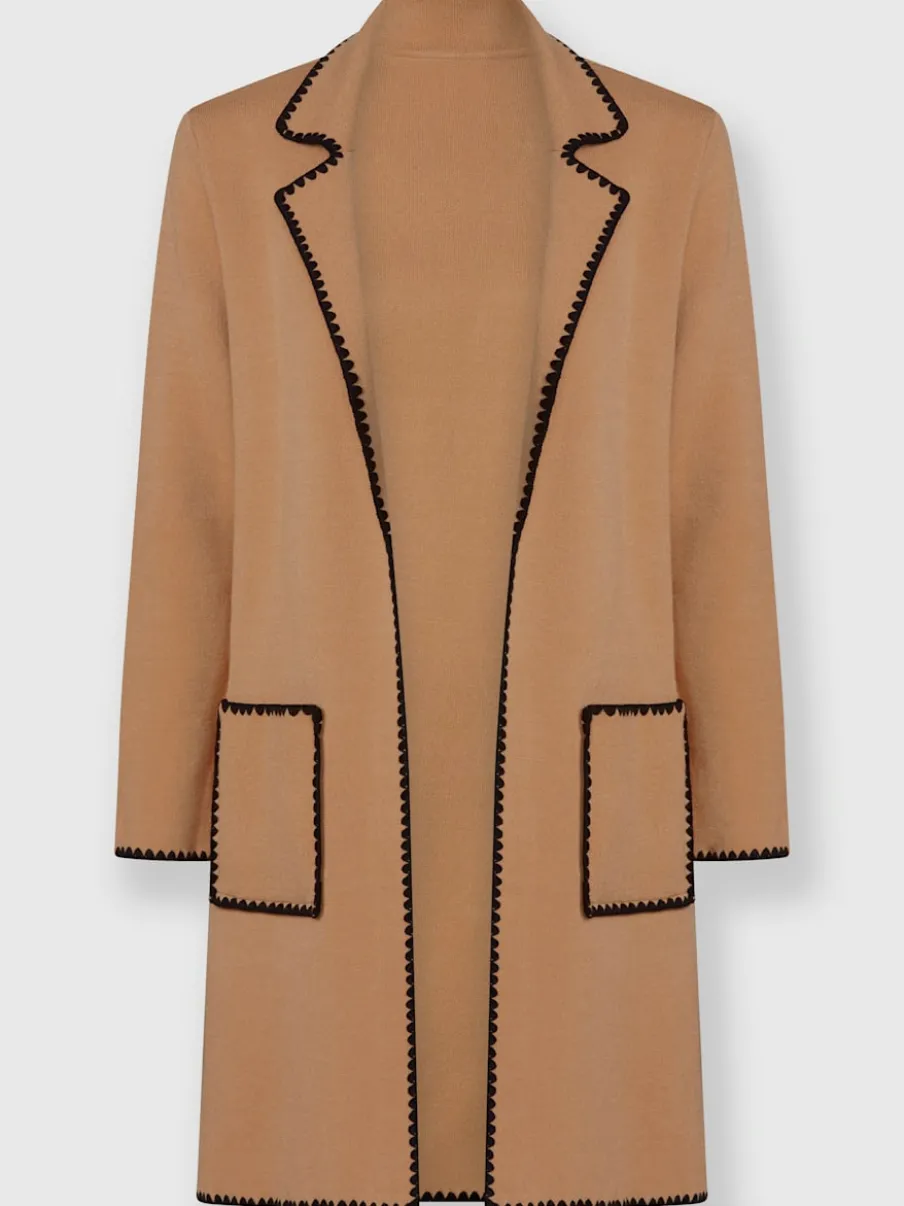 Manteau en tricot avec coutures contrastées et broderies