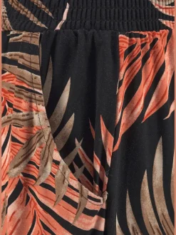Pantalon de plage avec imprimé feuilles de palmier et poches fendues