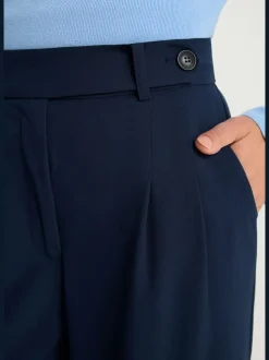 Pantalon large avec pinces à poches fendues et décoratives