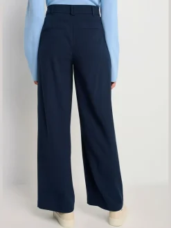 Pantalon large avec pinces à poches fendues et décoratives