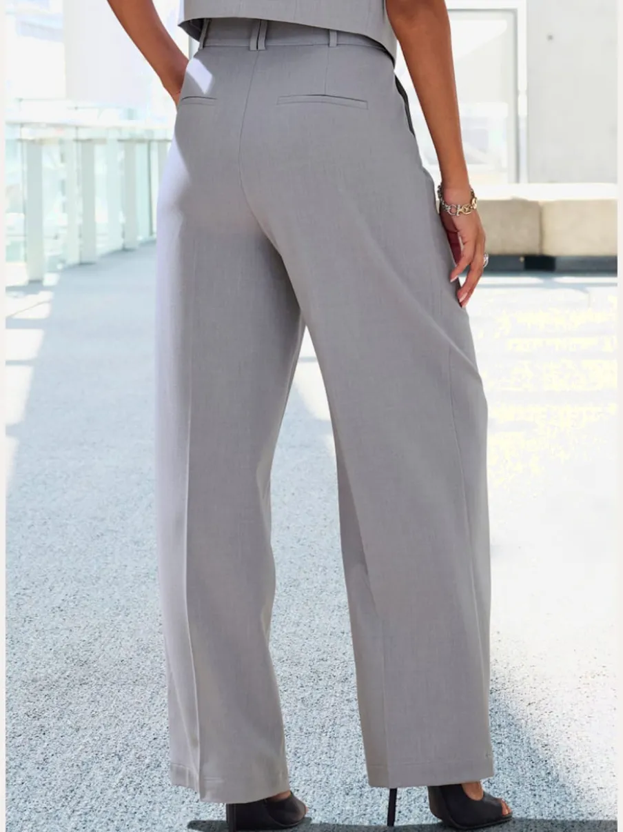 Pantalon large avec pinces à poches fendues et décoratives