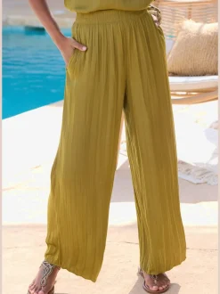 Pantalon à large ceinture élastique avec jambes plissées et poches latérales