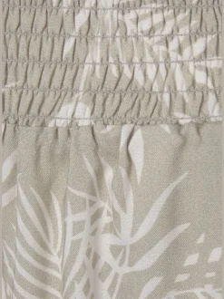 Pantalon large en viscose crêpée avec ceinture smockée et poches latérales
