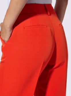 Pantalons à jambes larges avec plis et poches décoratives