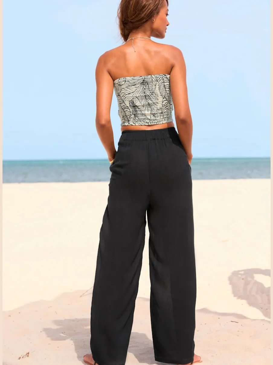 Pantalons larges en viscose avec poches latérales fendues