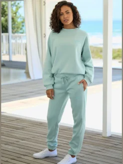 Pantalon sweat avec logo brodé et poches latérales fendues