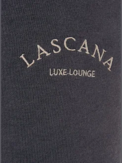 Pantalon sweat avec logo brodé et poches latérales fendues