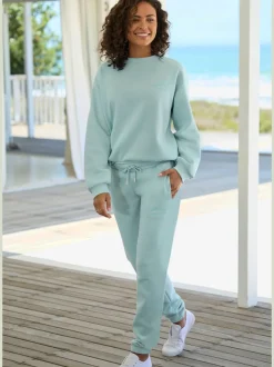 Pantalon sweat avec logo brodé et poches latérales fendues