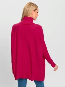 Pull ample à col roulé avec poches décoratives boutons