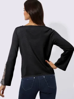 Pull en tricot fin avec encolure V et manches évasées ornées de dentelle