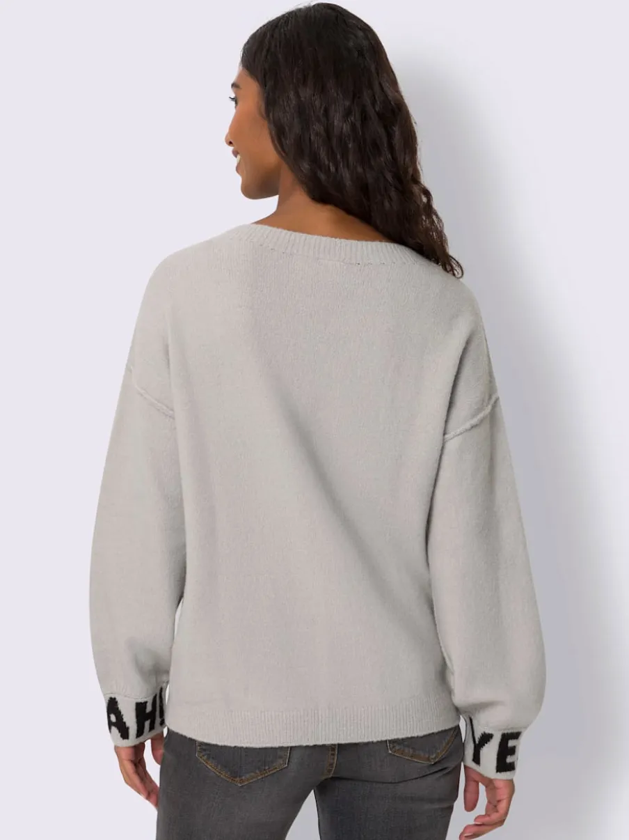 Pull en tricot à inscriptions devant et sur les manches longues avec encolure ronde et bords-côtes