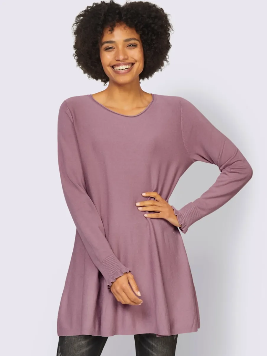 Pull long légèrement évasé avec bords roulés et volants