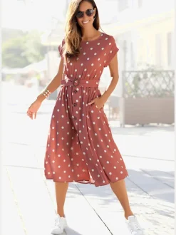 Robe mi-longue à pois avec ceinture et poches latérales