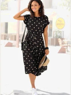 Robe mi-longue à pois avec ceinture et poches latérales