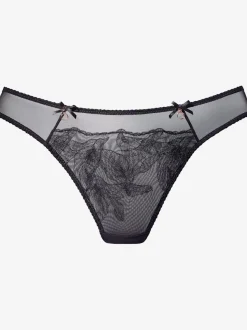 String extravagant avec nœuds décoratifs et accessoires devant sur le côté