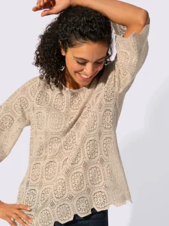 Tunique en dentelle avec encolure ronde et manches trompettes