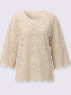 Tunique en dentelle avec encolure ronde et manches trompettes
