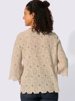 Tunique en dentelle avec encolure ronde et manches trompettes