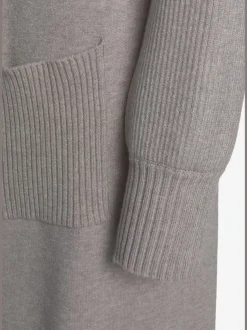 Veste en tricot long avec col châle et poches ouvertes