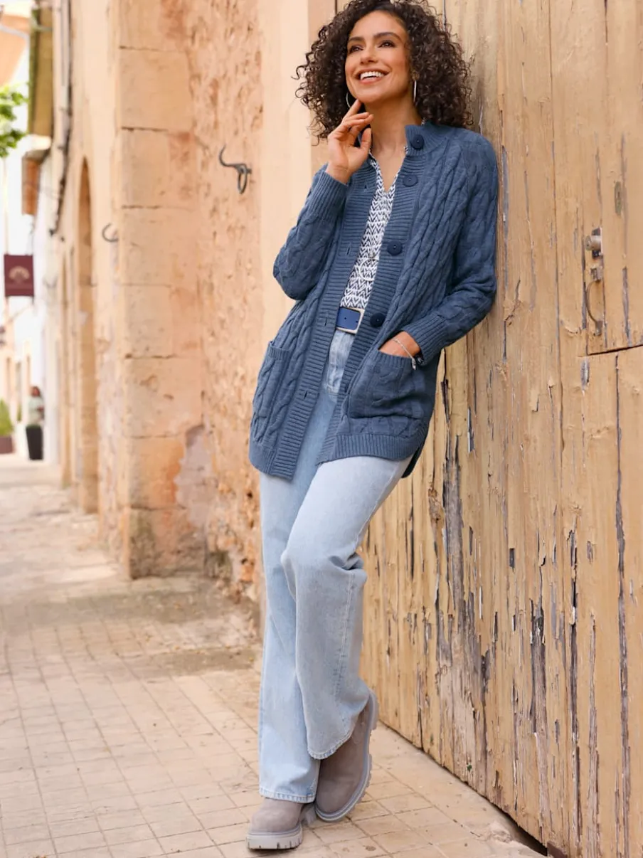 Veste en tricot torsadé avec col montant et poches