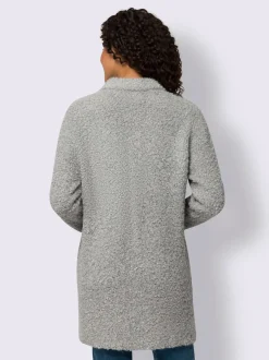 Veste longue en tricot avec col montant et poches plaquées