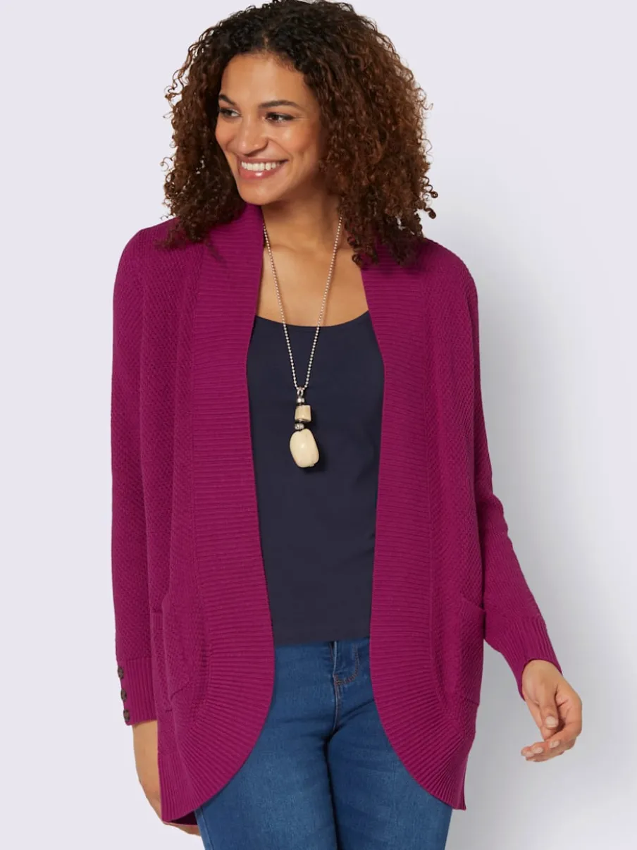 Veste longue en tricot avec poches et boutons côtelés